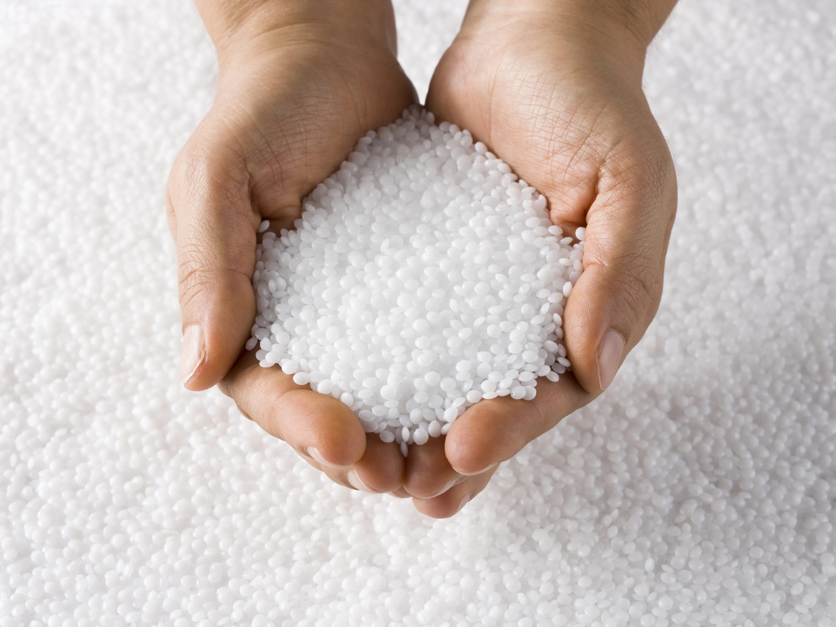 hand with clear pellets